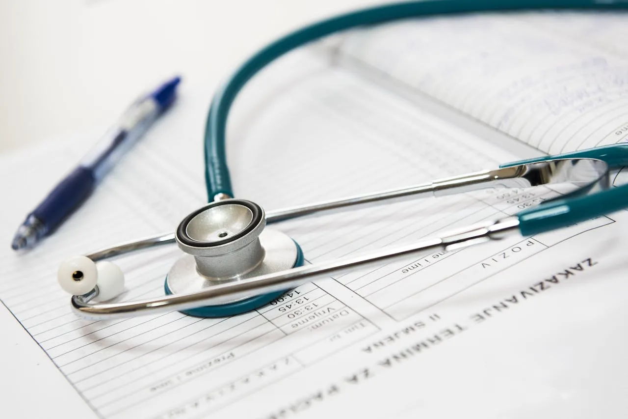 our-services-2 A stethoscope and pen resting on a medical report in a healthcare setting.