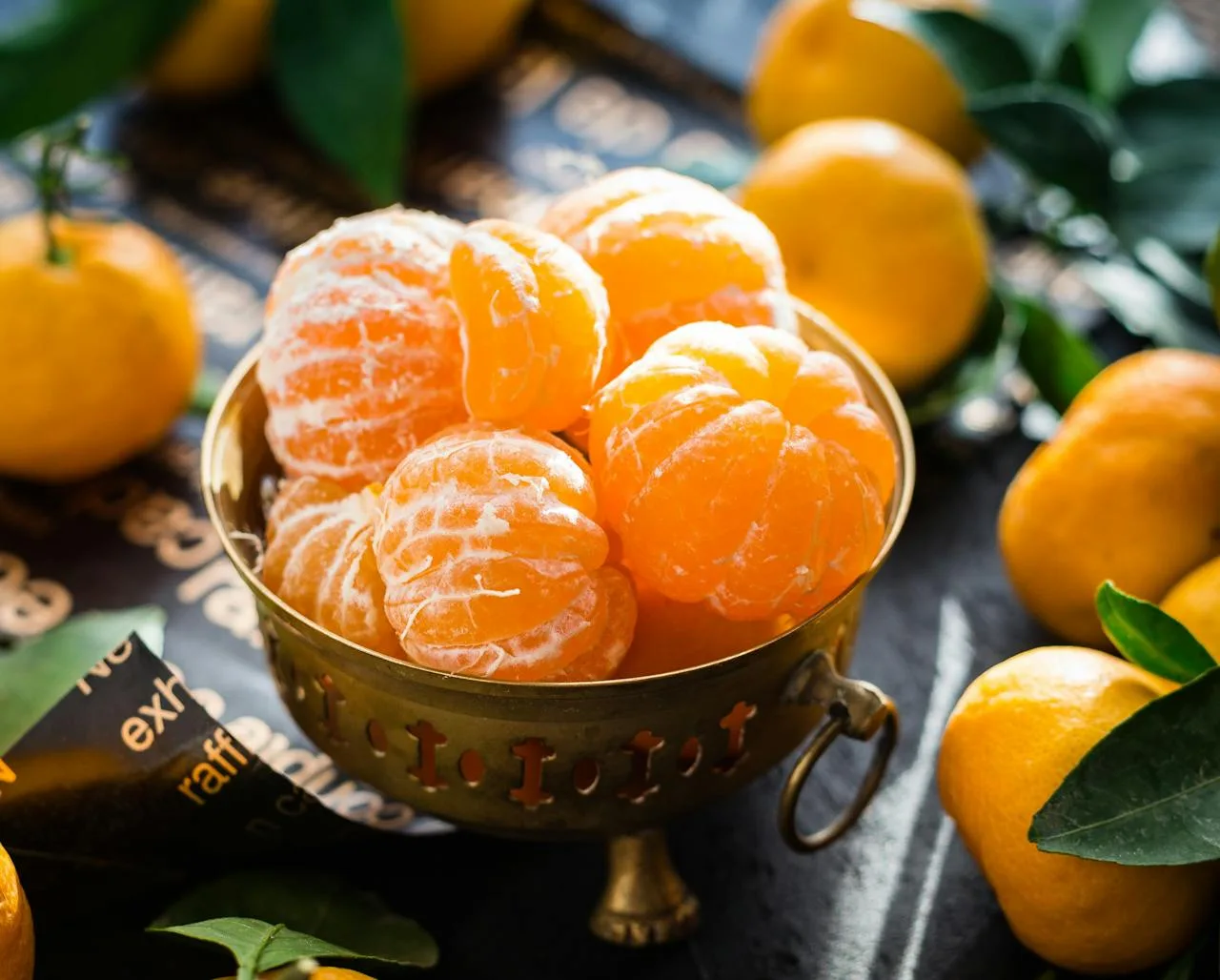 gallery-3 Vibrant peeled and whole tangerines in a rustic bowl highlighting freshness and health.