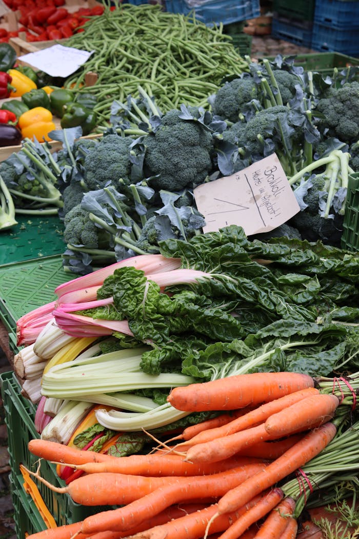 Vibrant display of fresh organic vegetables at an outdoor market, showcasing diverse produce.